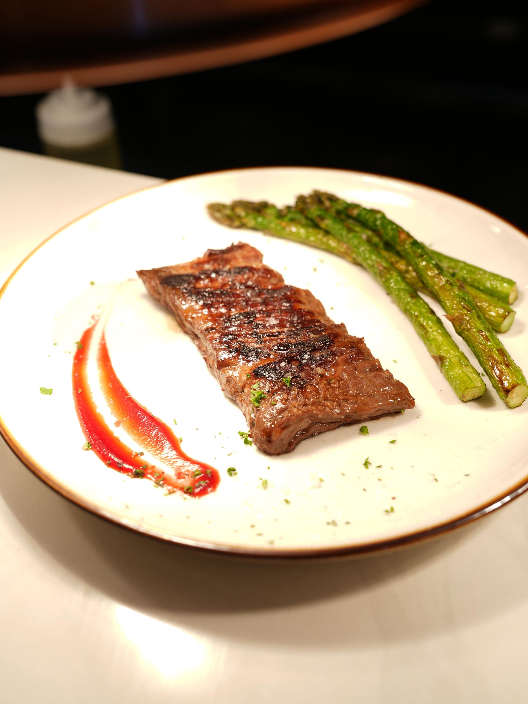 Grilled steak with asparagus and red pepper sauce at Madrid Tapas y Vinos